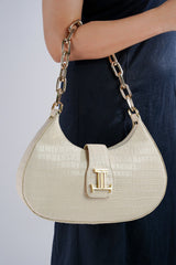 Womens leather shoulder baguette bag with croco texture and gold chain in off white colour by JULKE