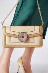 Womens shoulder clutch bag in light gold leather with diamante flower by JULKE