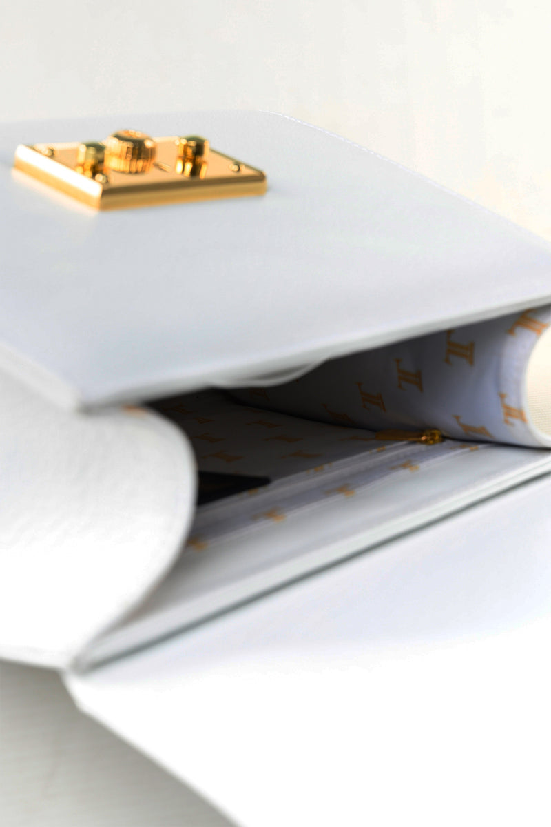 Womens statement leather hand bag in white colour with gold lock by JULKE