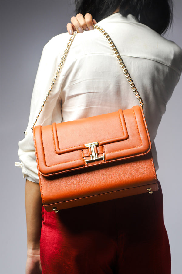Womens leather shoulder bag with gold chain strap in orange tan colour by JULKE